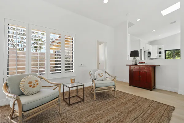 a bedroom with furniture and a large window