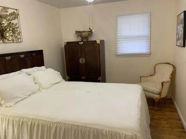 a bedroom with a bed and a chair