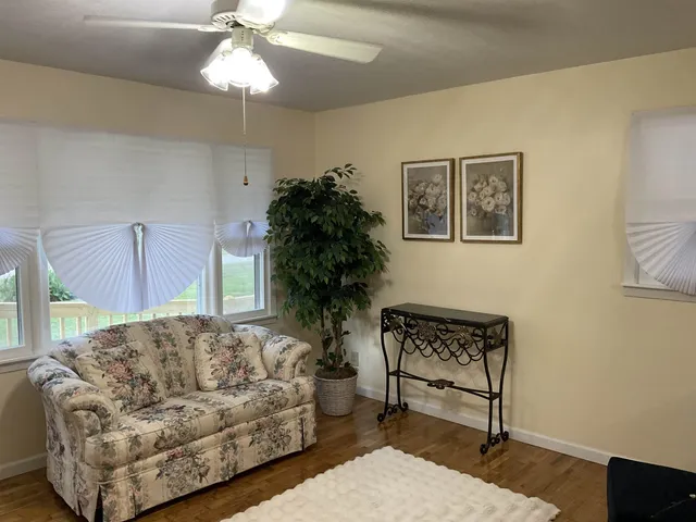 a living room with furniture and a chandelier