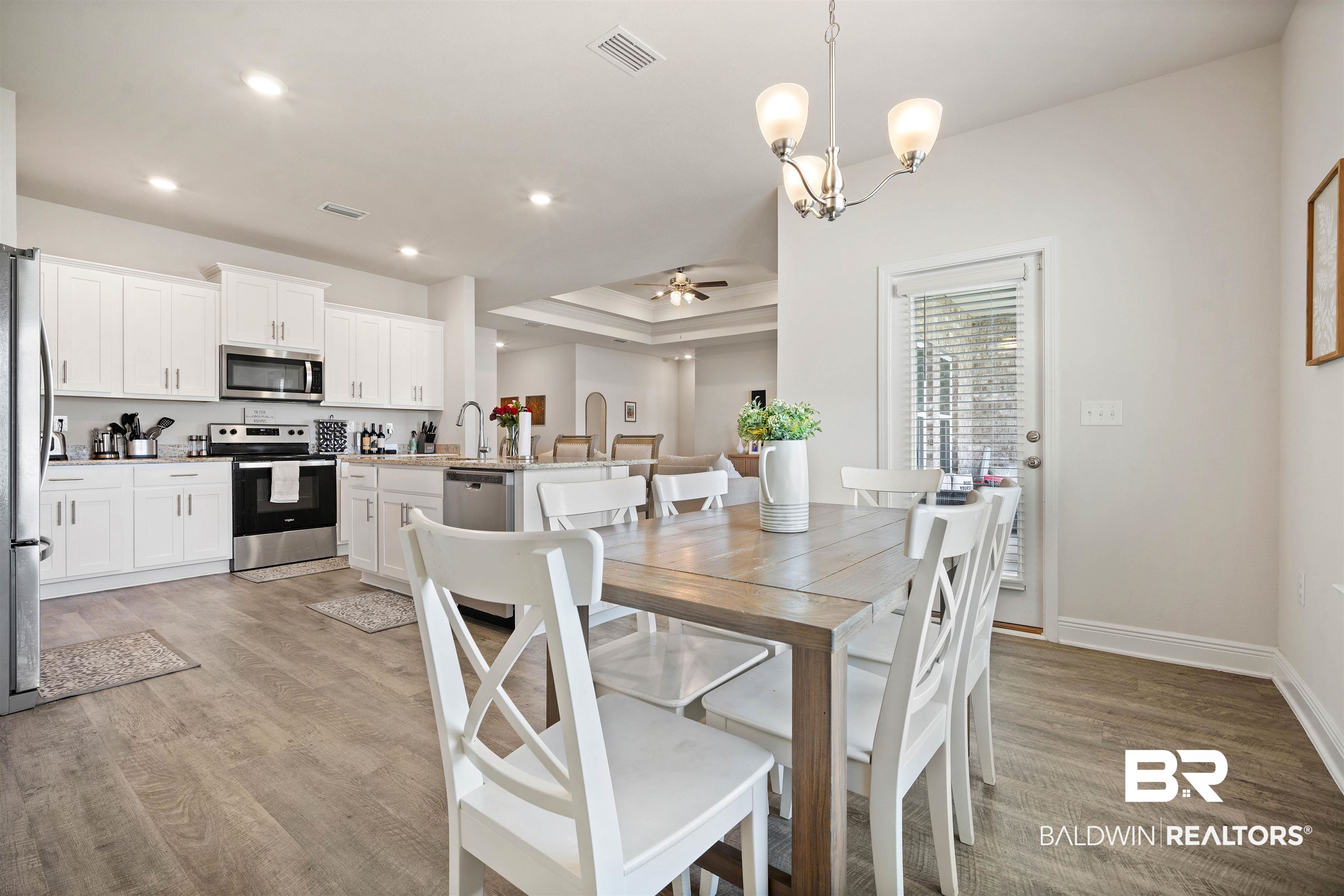 11021 Native Dancer Way Daphne, AL 36526 - Photo 10 of 35 Dining room featuring light wood finished floors, visible vents, recessed lighting, and ceiling fan with notable chandelier