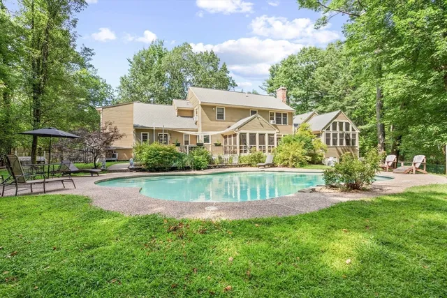 a view of a house with a patio and a yard