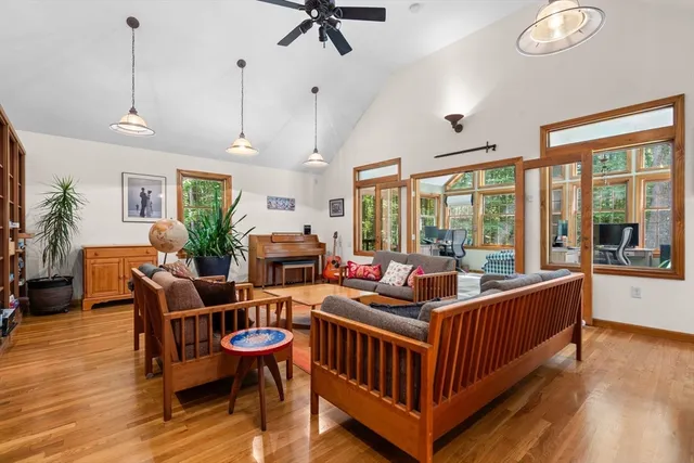 a living room with furniture a table and a large window