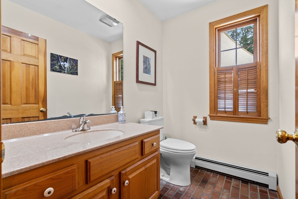 9 Stagecoach Road Princeton, MA 01541 - Photo 18 of 42 a bathroom with a granite countertop sink a toilet and a large mirror