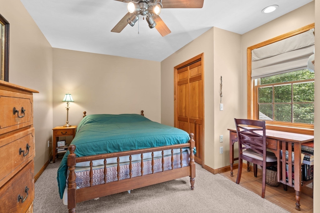 9 Stagecoach Road Princeton, MA 01541 - Photo 25 of 42 a bedroom with a bed and a chandelier