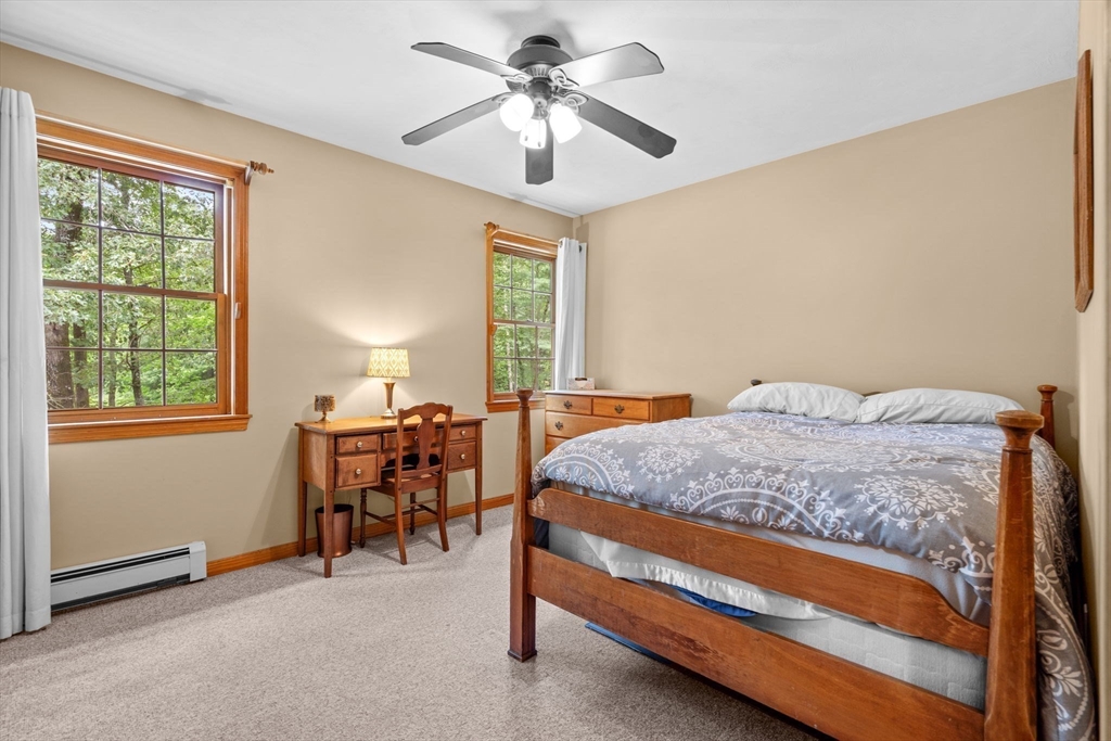 9 Stagecoach Road Princeton, MA 01541 - Photo 26 of 42 a bedroom with a bed and a chandelier