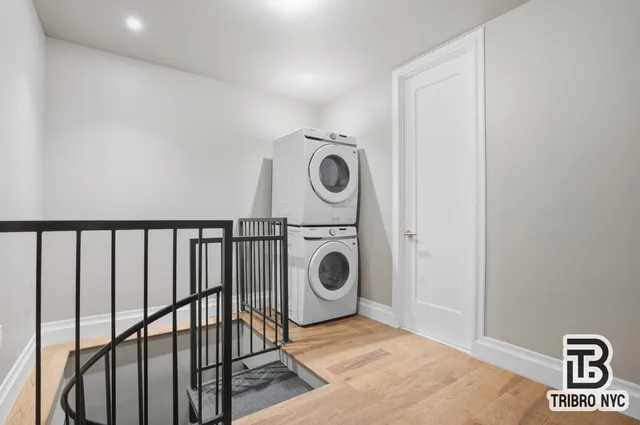a view of a hallway with washer and dryer