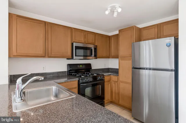 a kitchen with a refrigerator sink and stove