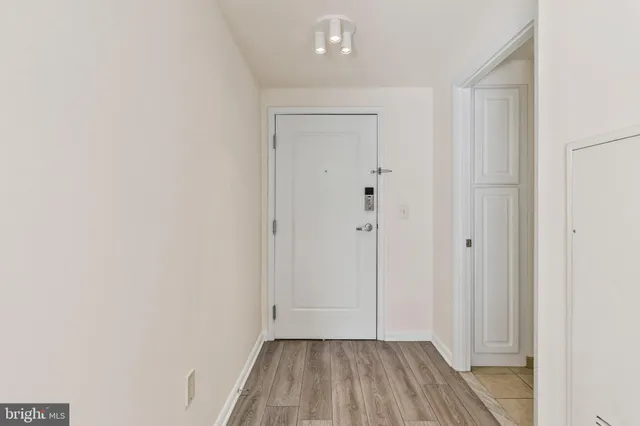 a view of hallway with wooden floor