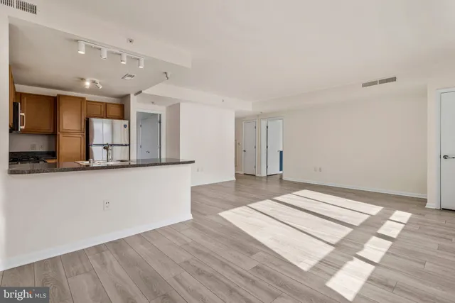 a view of a kitchen with wooden floor and a sink