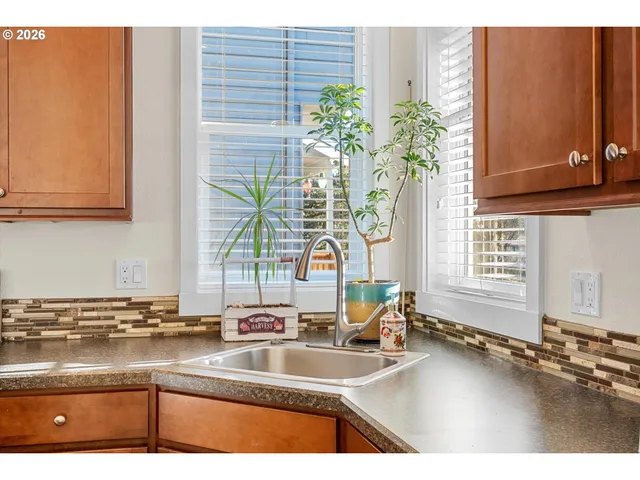 a kitchen with stainless steel appliances a sink a stove and a microwave