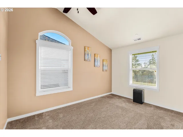 a view of an empty room with a ceiling fan