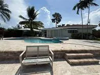 a view of swimming pool with a table and chairs
