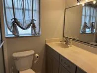 a bathroom with a sink a toilet and mirror