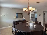 a view of a dining room with furniture and chandelier