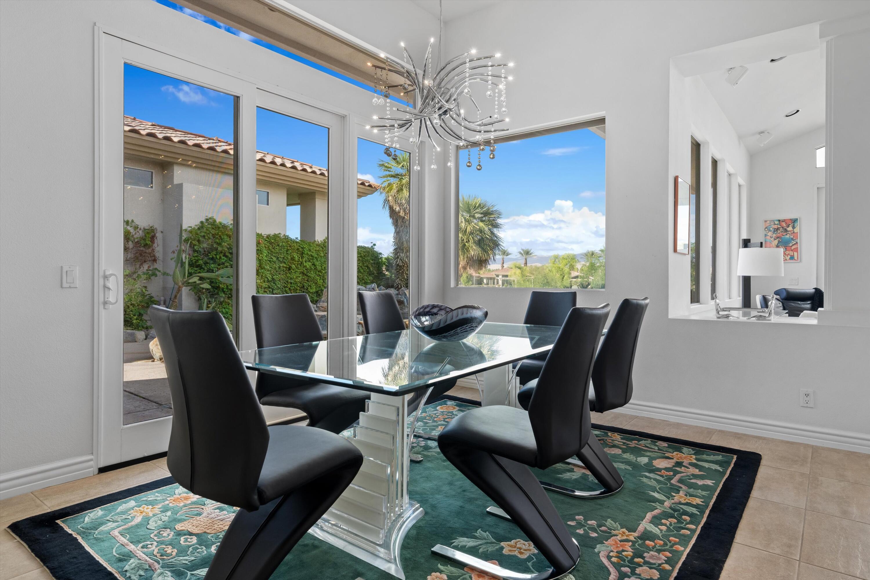 870 Deer Haven Circle Palm Desert, CA 92211 - Photo 11 of 37 a view of a dining room with furniture a rug and wooden floor