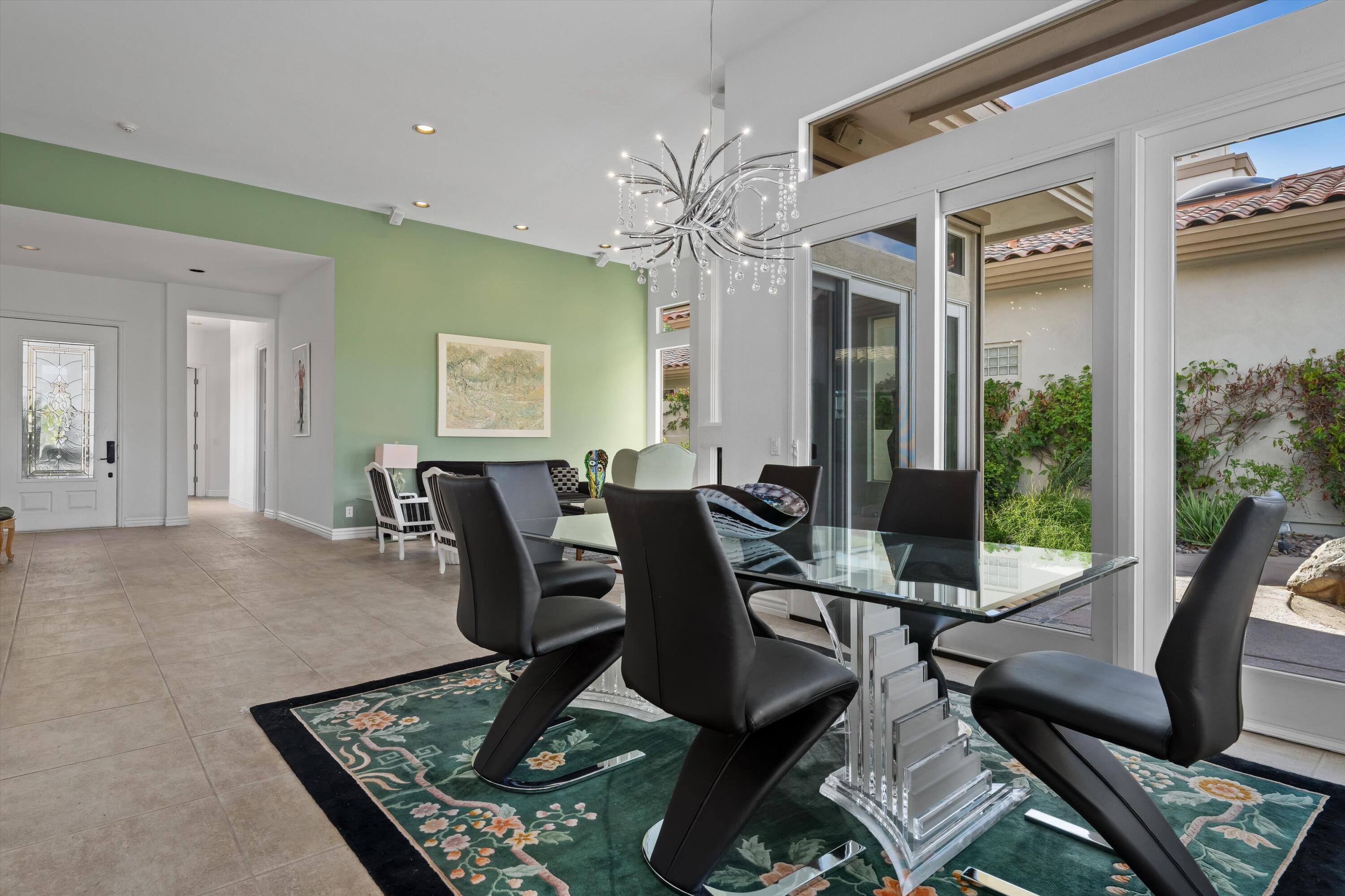 870 Deer Haven Circle Palm Desert, CA 92211 - Photo 12 of 37 a dining room with furniture a rug and a chandelier