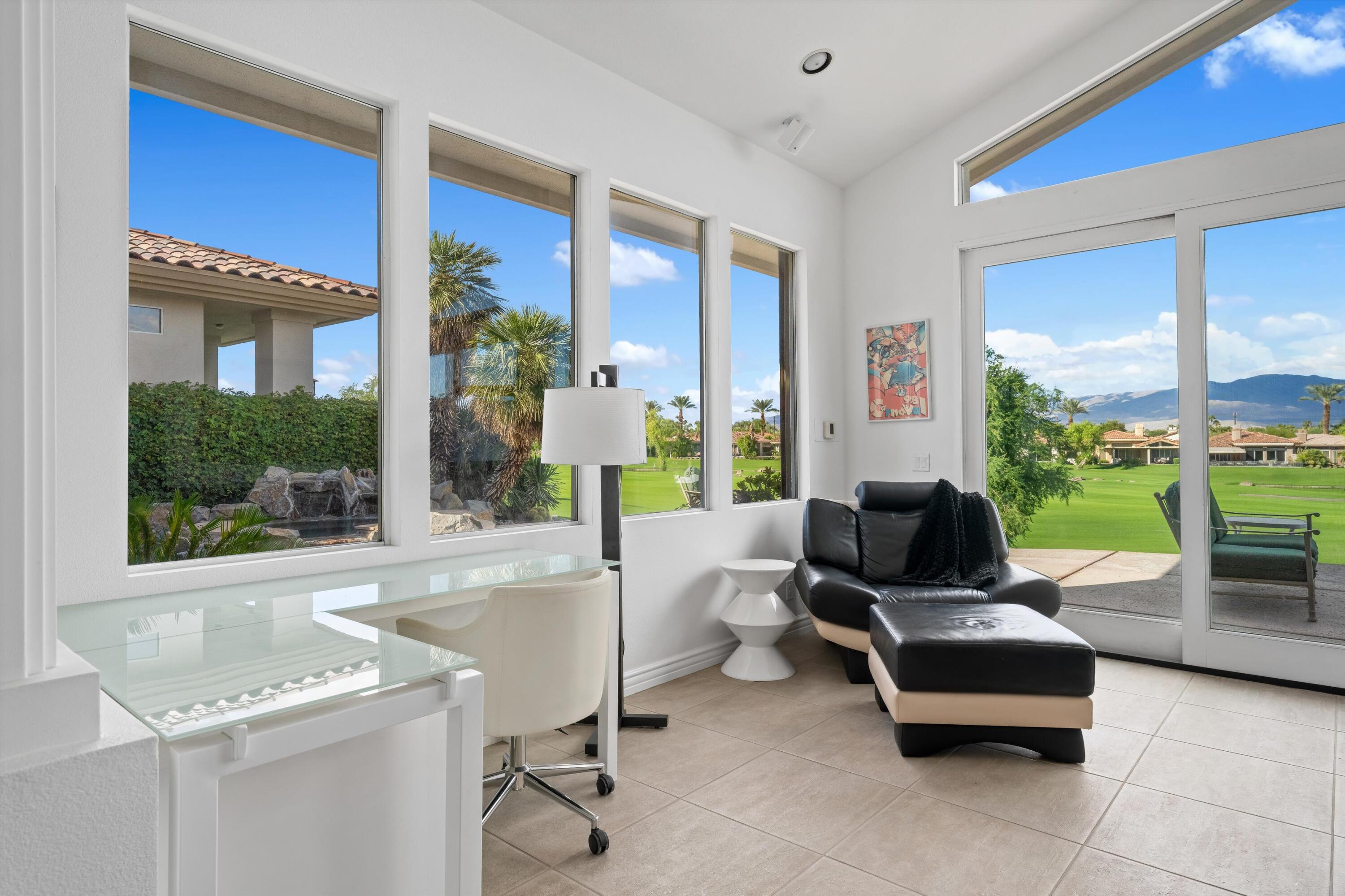 870 Deer Haven Circle Palm Desert, CA 92211 - Photo 16 of 37 a living room with patio furniture and a floor to ceiling window