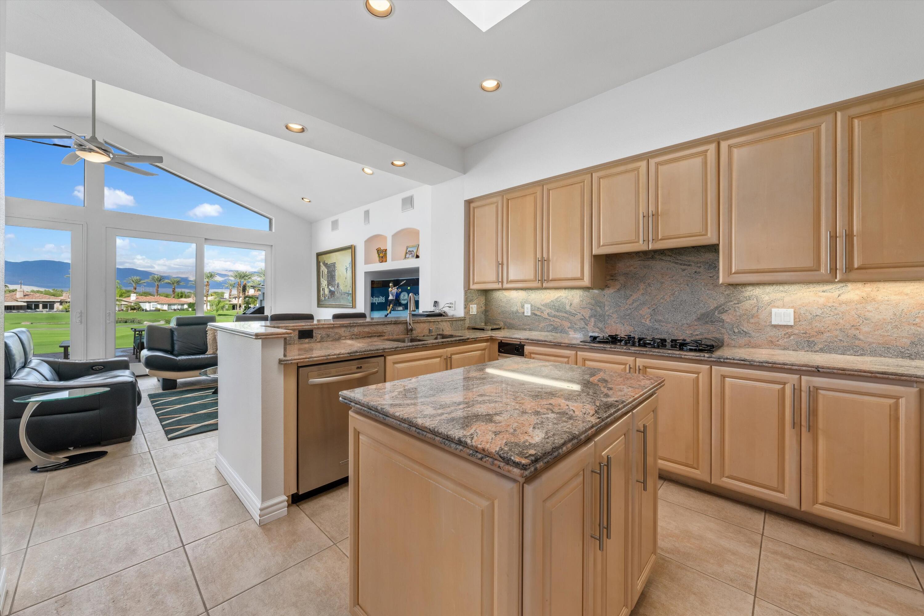 870 Deer Haven Circle Palm Desert, CA 92211 - Photo 19 of 37 a kitchen with a sink stove and cabinets