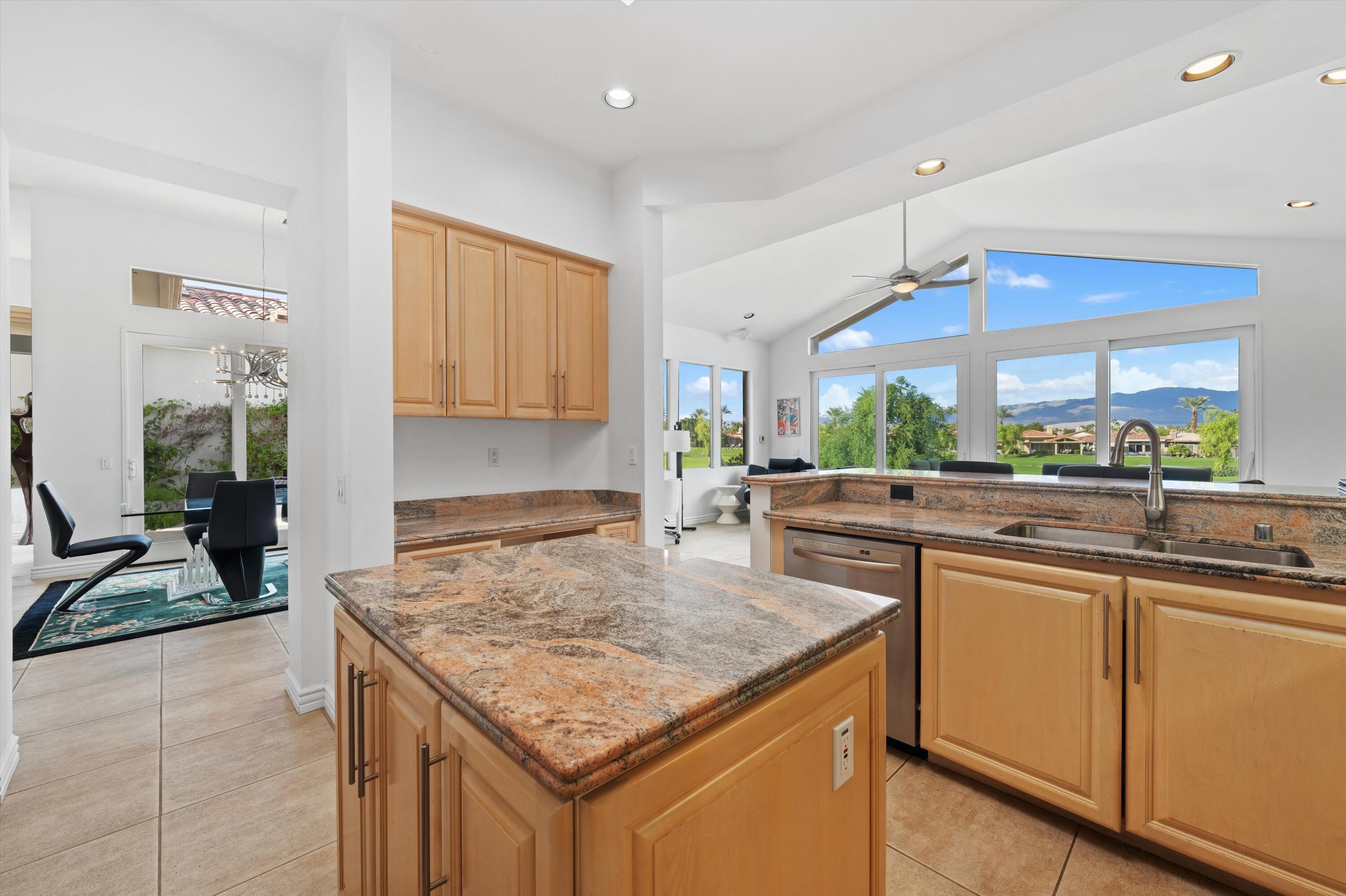 870 Deer Haven Circle Palm Desert, CA 92211 - Photo 20 of 37 a kitchen with lots of counter top space and living room