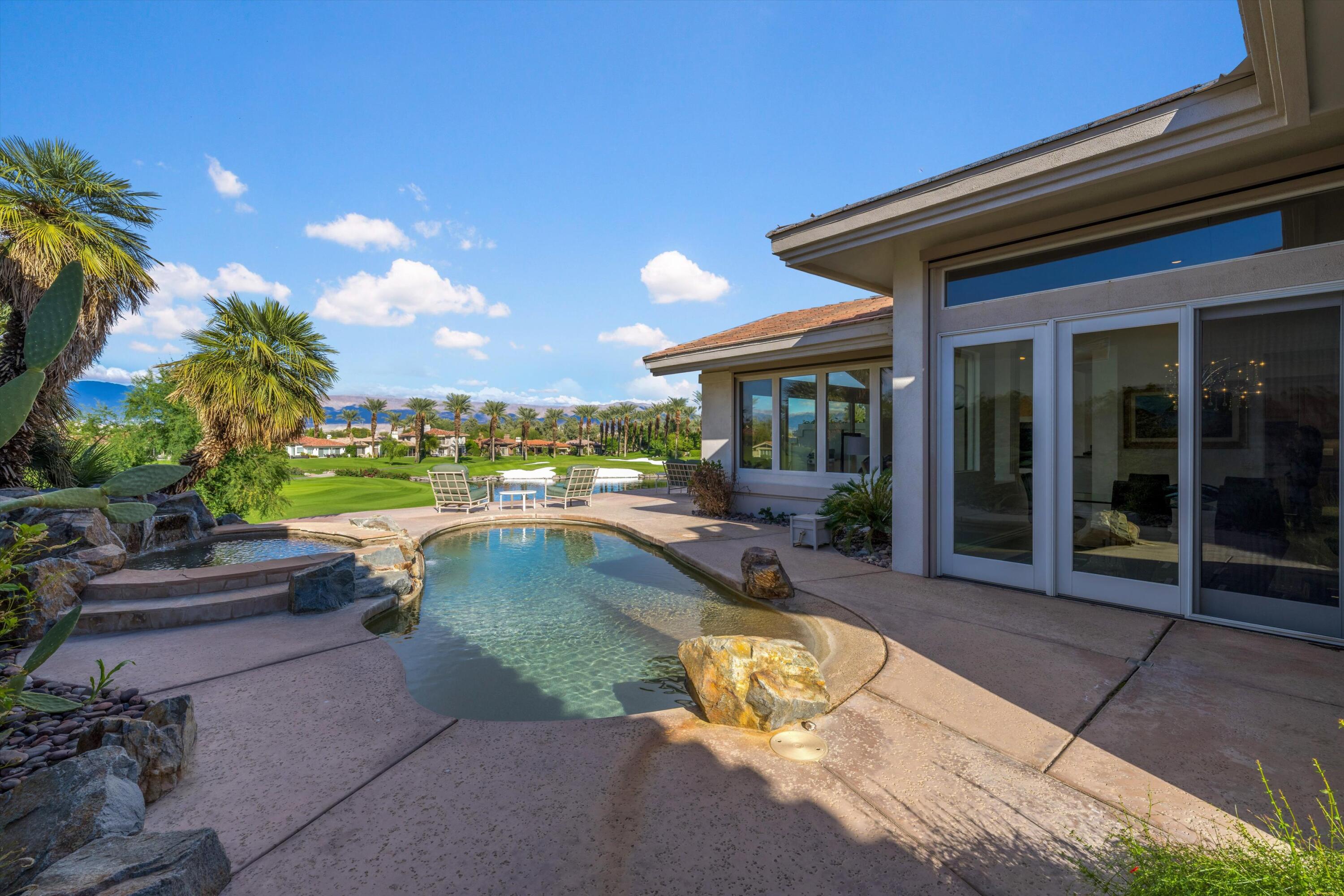 870 Deer Haven Circle Palm Desert, CA 92211 - Photo 2 of 37 a view of a swimming pool with lounge chair