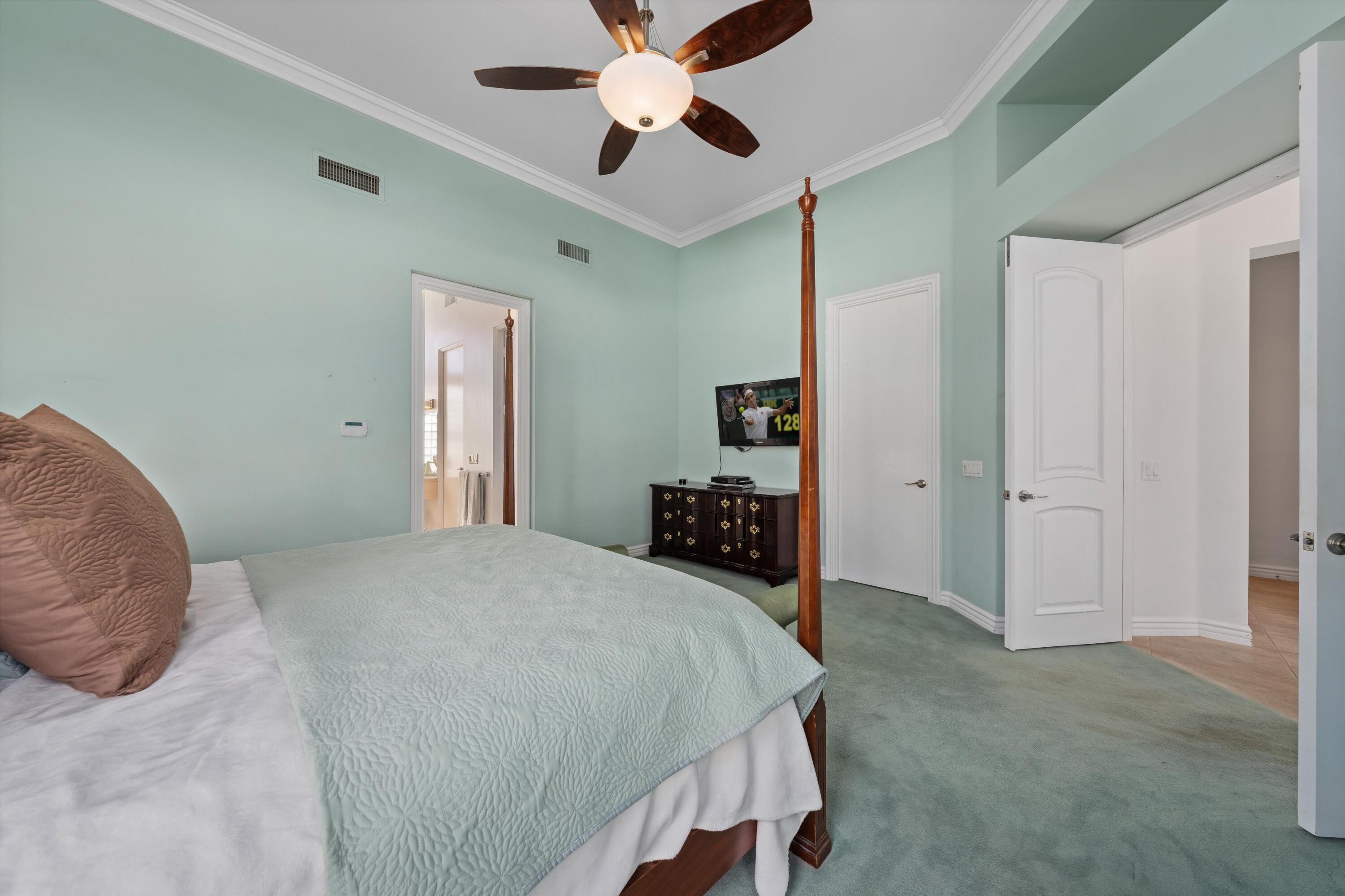 870 Deer Haven Circle Palm Desert, CA 92211 - Photo 25 of 37 a bedroom with a bed and a chandelier