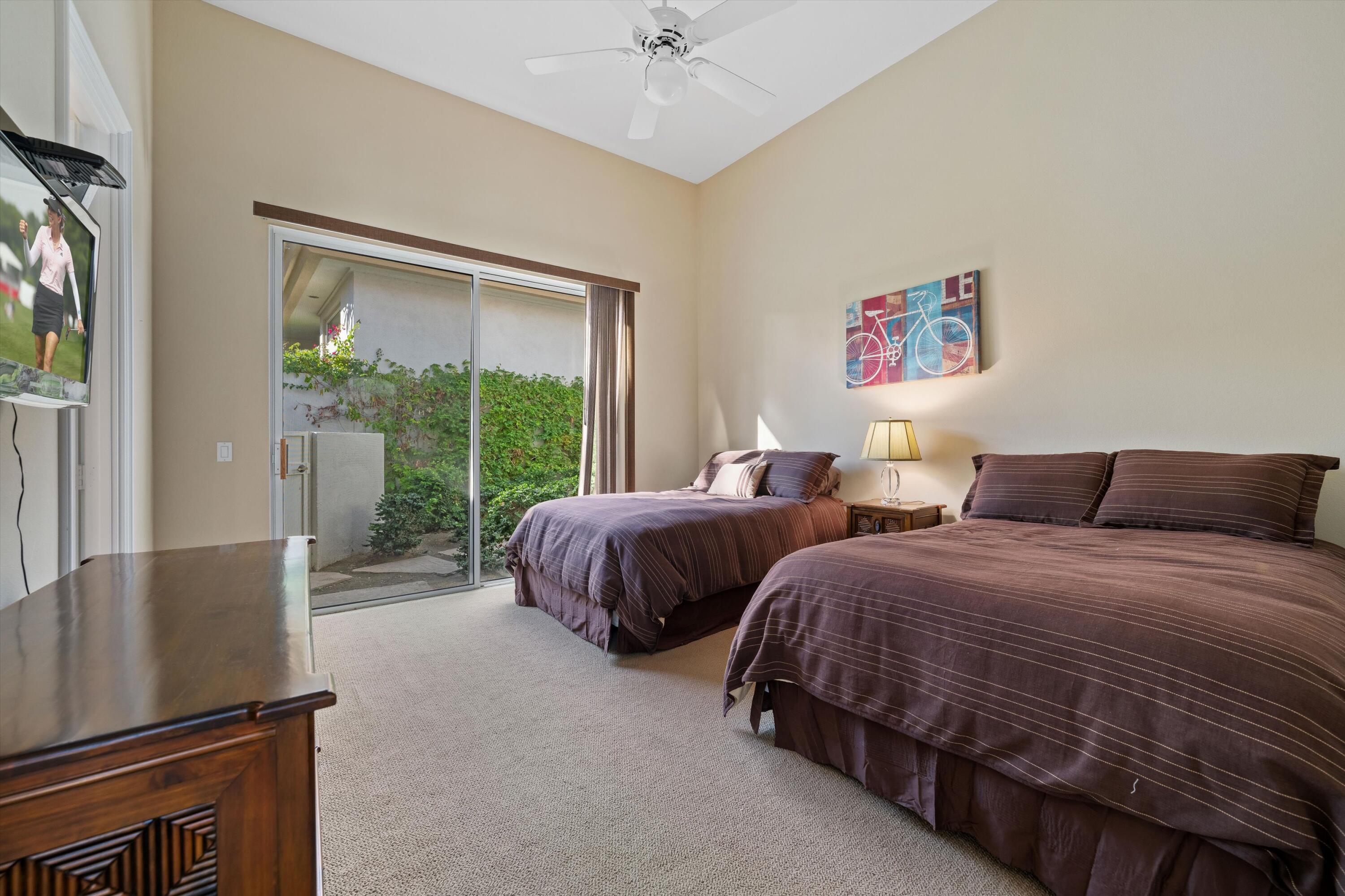 870 Deer Haven Circle Palm Desert, CA 92211 - Photo 28 of 37 a bedroom with two beds and a large window