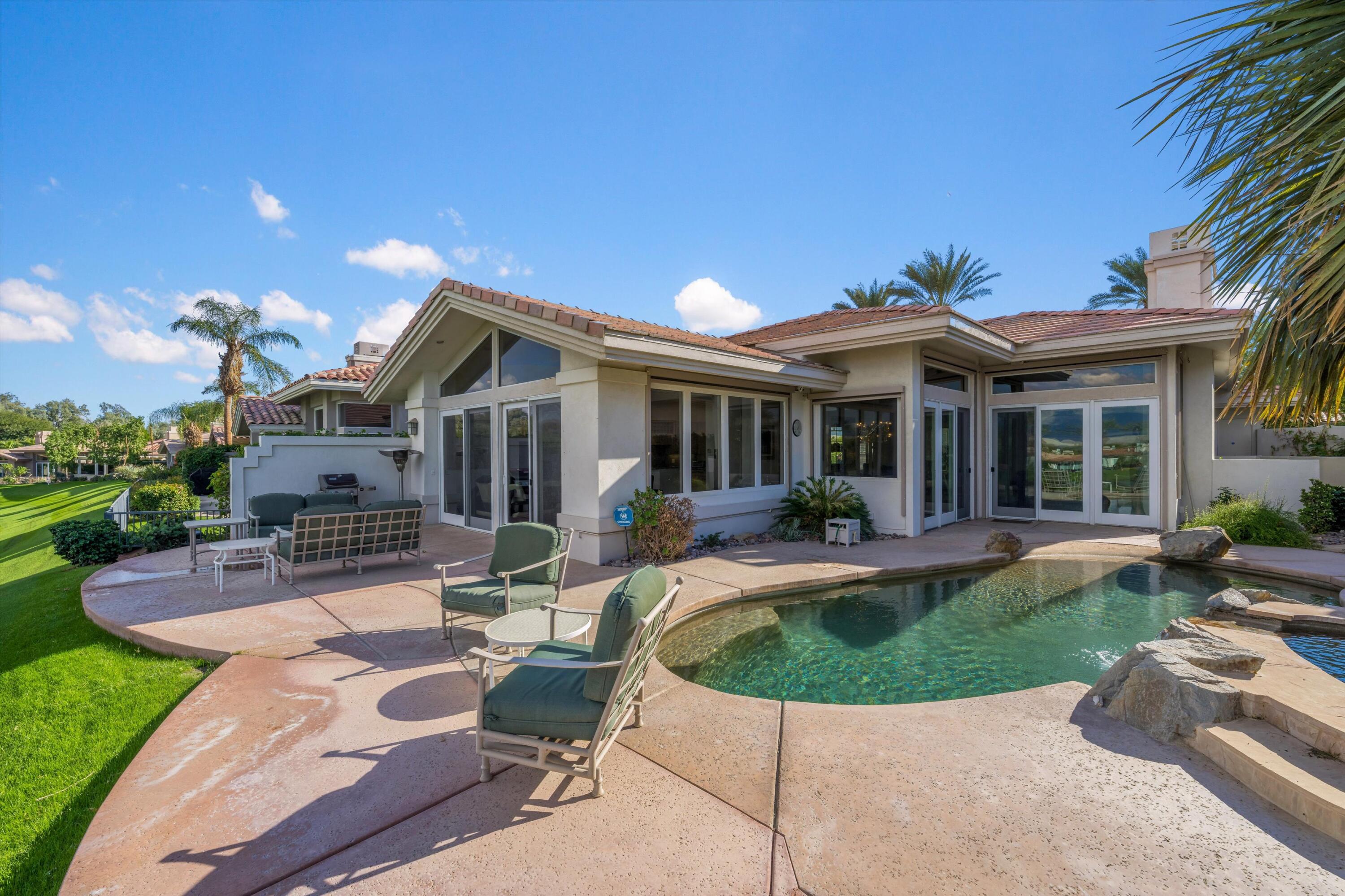 870 Deer Haven Circle Palm Desert, CA 92211 - Photo 32 of 37 a view of a house with backyard sitting area and porch