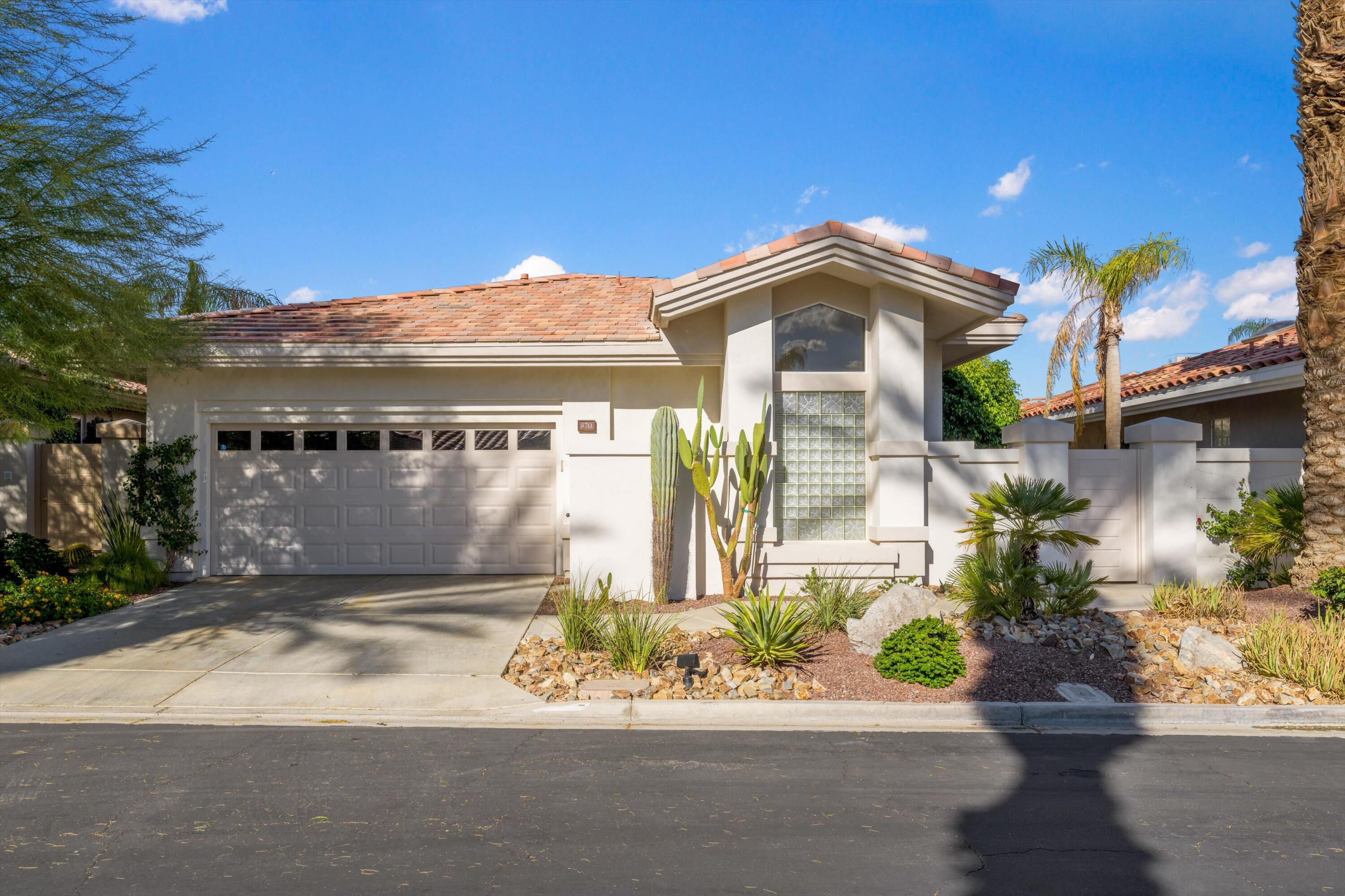 870 Deer Haven Circle Palm Desert, CA 92211 - Photo 4 of 37 a front view of a house with a yard