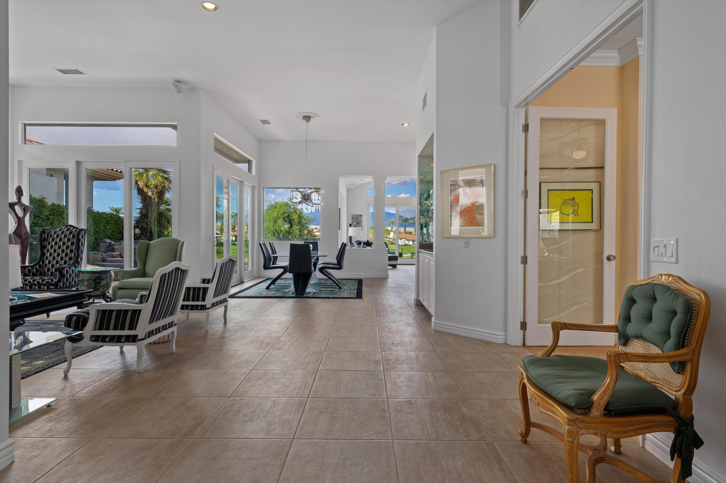 870 Deer Haven Circle Palm Desert, CA 92211 - Photo 9 of 37 a living room with furniture and large windows