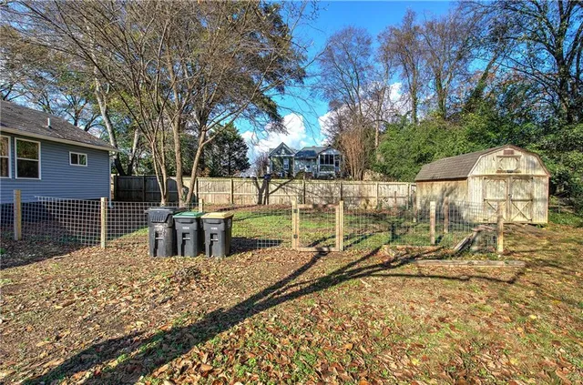 a backyard of a house with barbeque oven