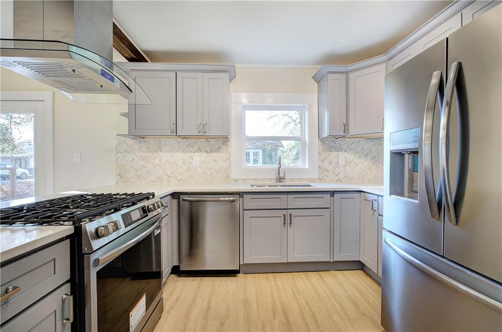 415 East 10th Street Rome, GA 30161 - Photo 21 of 42 a kitchen with stainless steel appliances granite countertop a sink stove and refrigerator