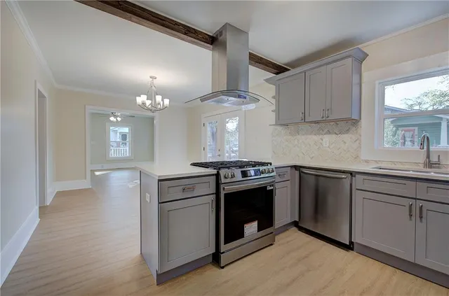 a kitchen with stainless steel appliances granite countertop a stove and a sink