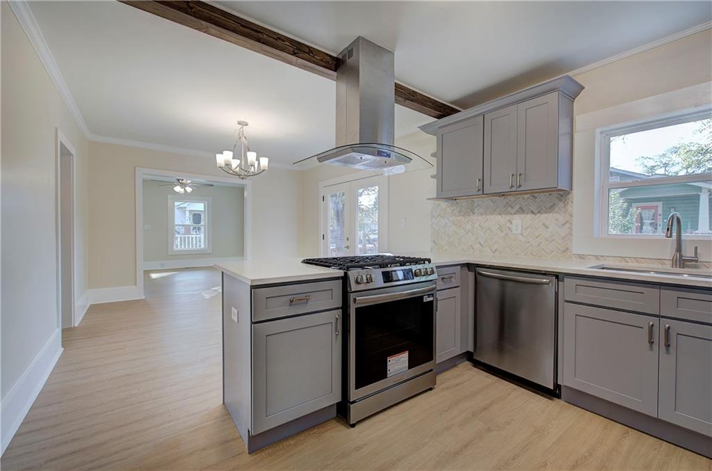 415 East 10th Street Rome, GA 30161 - Photo 22 of 42 a kitchen with stainless steel appliances granite countertop a stove and a sink