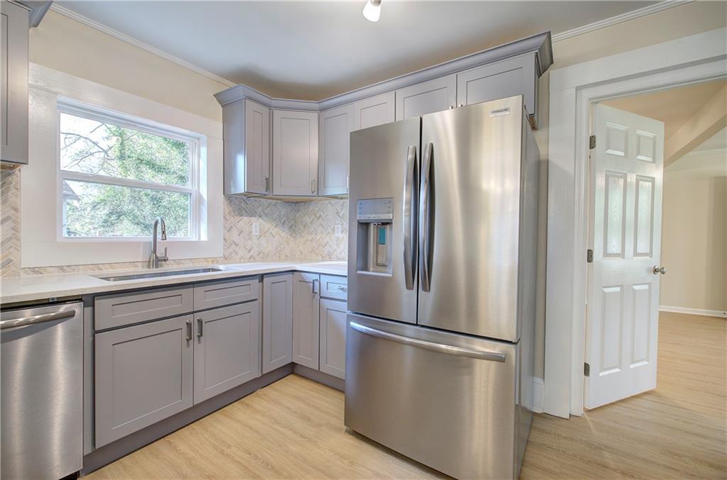 415 East 10th Street Rome, GA 30161 - Photo 23 of 42 a kitchen with stainless steel appliances a refrigerator and a sink