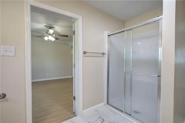 a bathroom with a shower and a light fixture