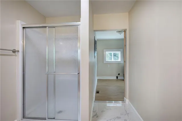 a bathroom with a glass shower door