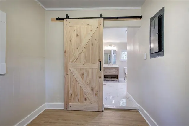 a view of a hallway with wooden floor and staircase
