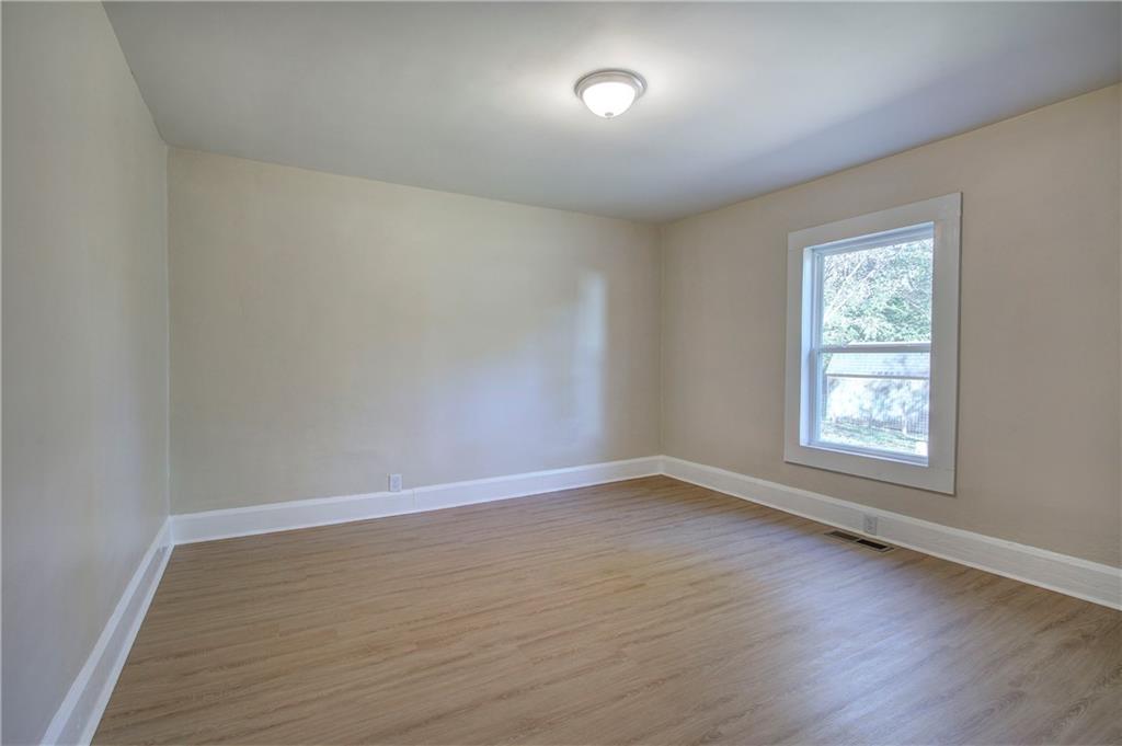 415 East 10th Street Rome, GA 30161 - Photo 36 of 42 an empty room with wooden floor and windows