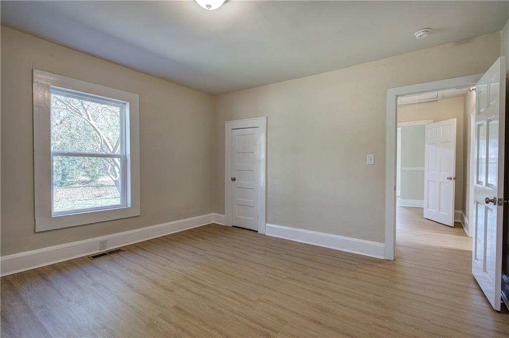 415 East 10th Street Rome, GA 30161 - Photo 37 of 42 an empty room with wooden floor and windows