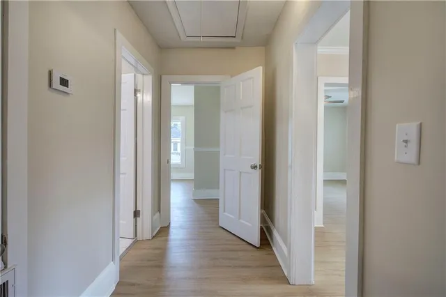 a view of a hallway with wooden floor