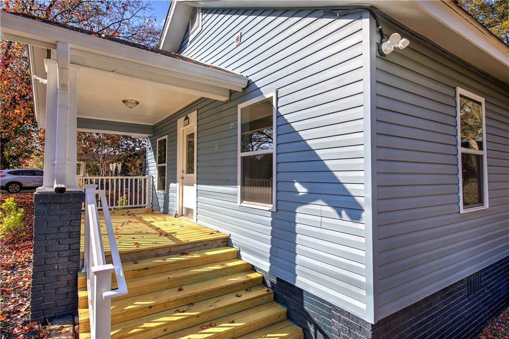 415 East 10th Street Rome, GA 30161 - Photo 9 of 42 a view of a patio with two couches and deck with wooden floor and fence