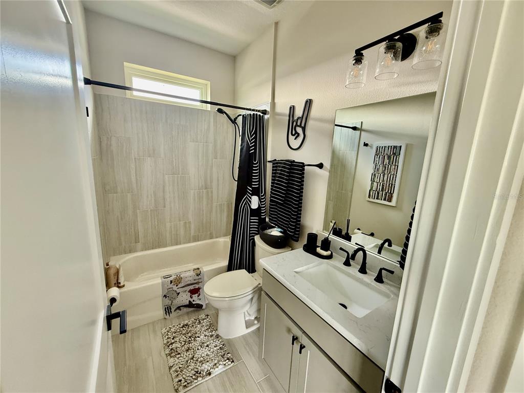 12030 Lakeshore Way Oxford, FL 34484 - Photo 13 of 38 a bathroom with a sink vanity mirror and toilet