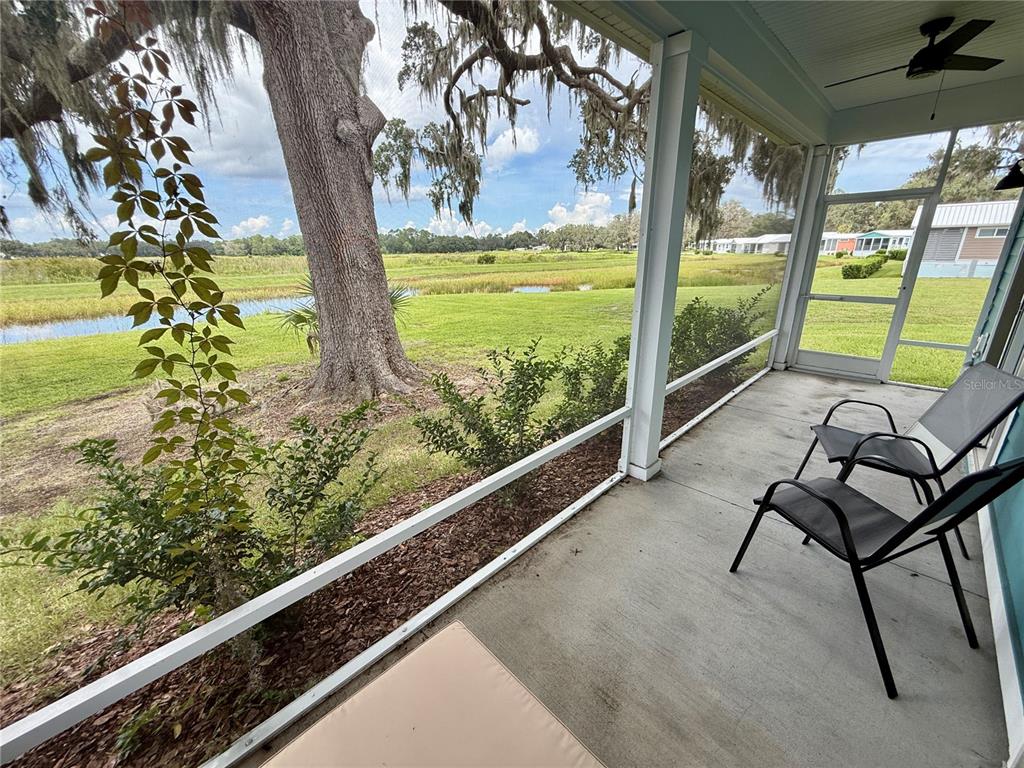 12030 Lakeshore Way Oxford, FL 34484 - Photo 14 of 38 a view of a two chair and table in the balcony