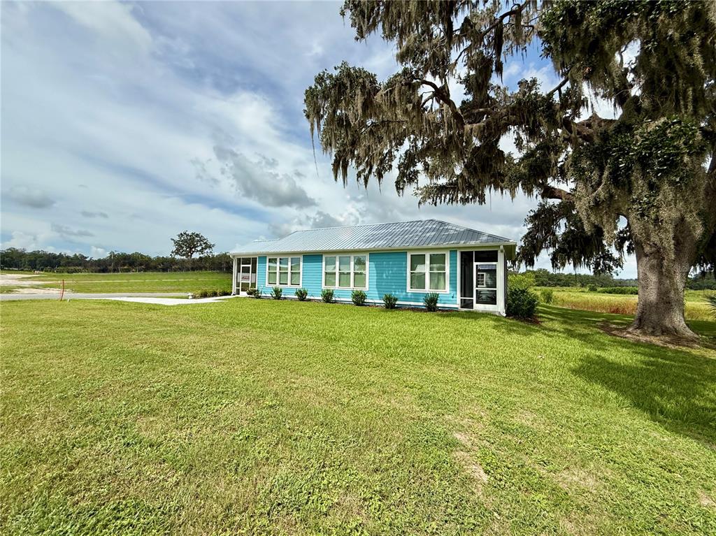 12030 Lakeshore Way Oxford, FL 34484 - Photo 20 of 38 a front view of a house with a garden and lake view