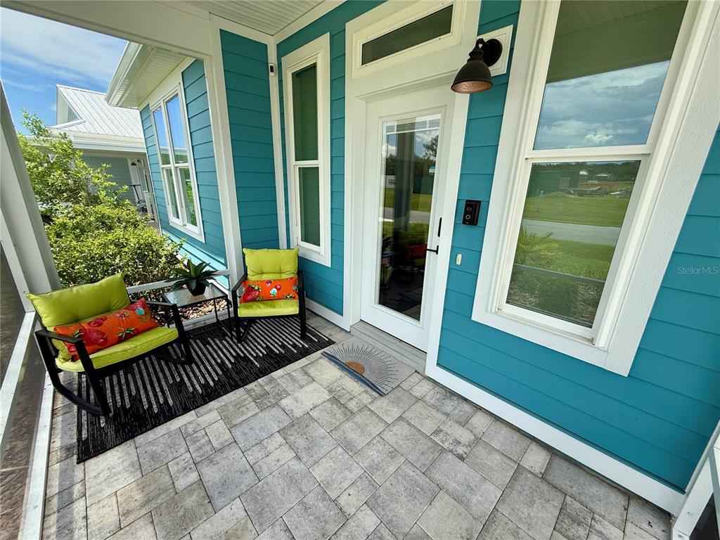 12030 Lakeshore Way Oxford, FL 34484 - Photo 2 of 38 a balcony with furniture and wooden floor
