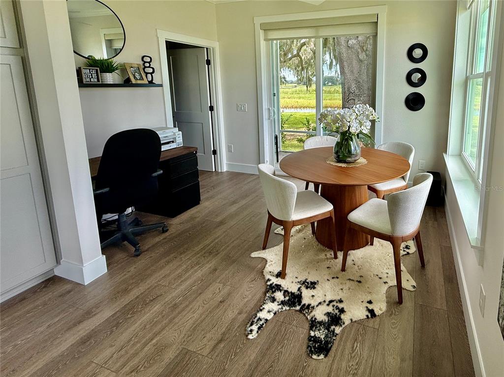 12030 Lakeshore Way Oxford, FL 34484 - Photo 7 of 38 a view of a dining room with furniture and wooden floor