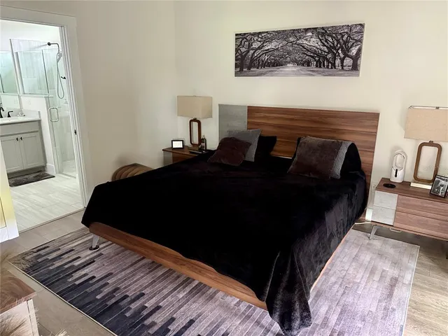 a bedroom with bed and wooden floor