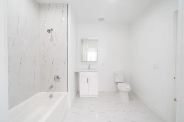a bathroom with a bathtub toilet and sink