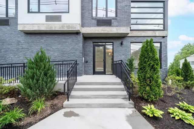 a view of a house with potted plants