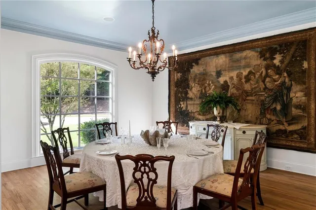 a kitchen with granite countertop a table and chairs in it